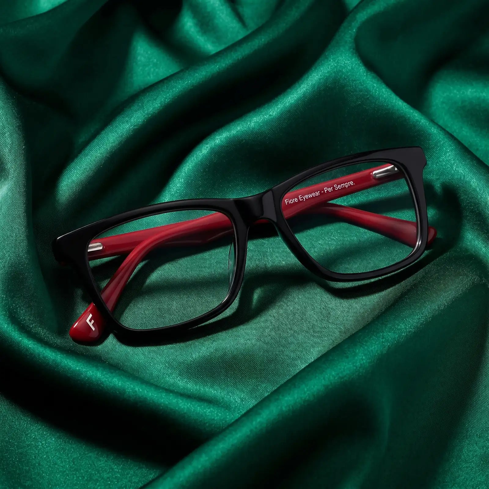 Fiore 5228 eyeglasses in black – nested in flowing emerald silk