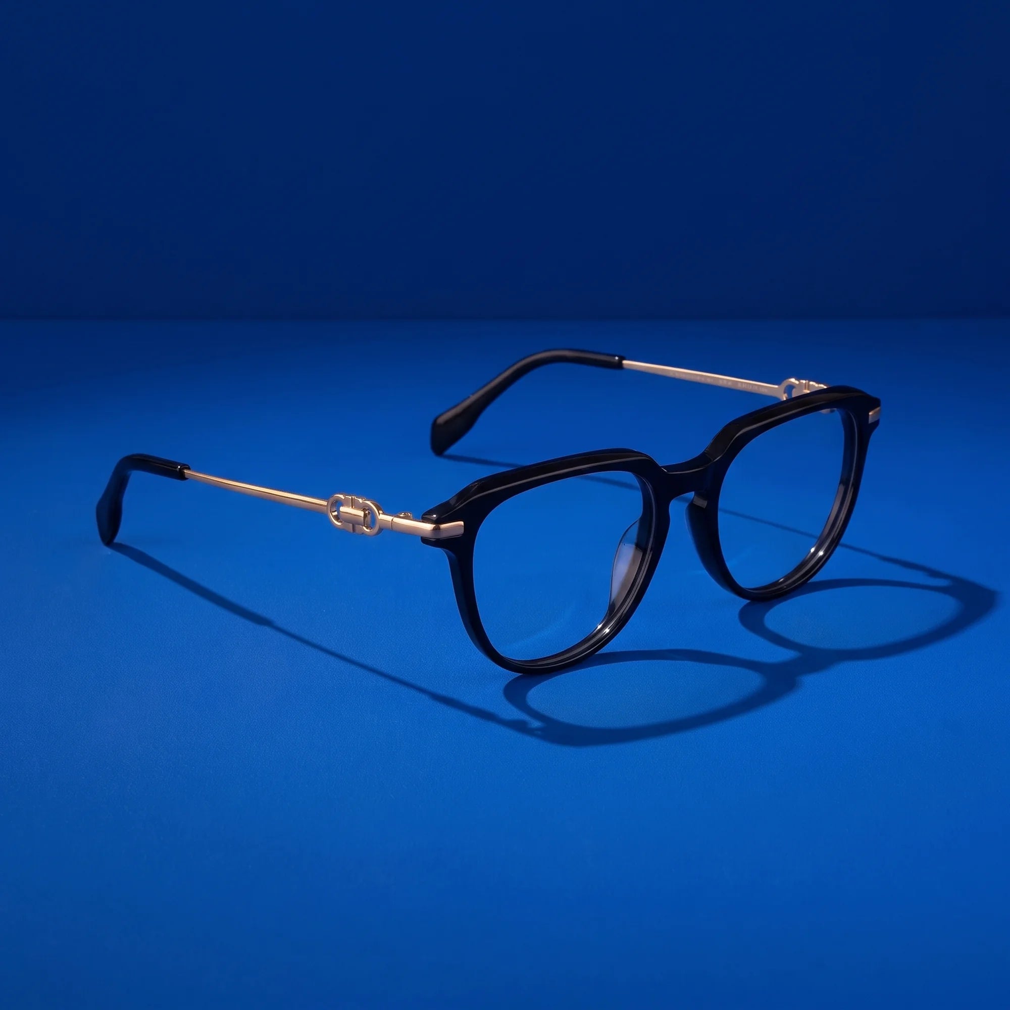 Fiore 5409 eyeglasses in black – hero still life against a deep cobalt backdrop