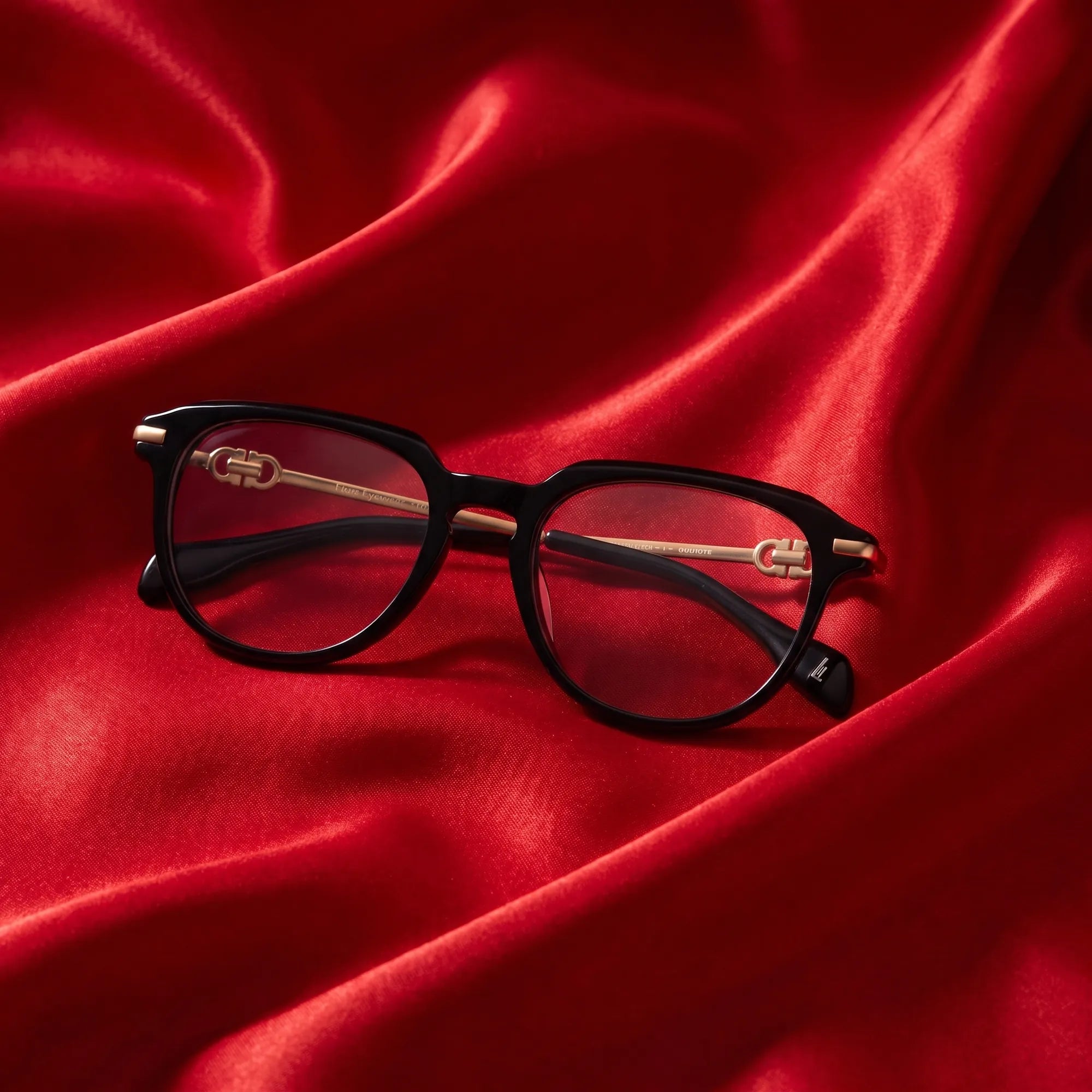 Fiore 5409 eyeglasses in black – nested in flowing vivid red silk