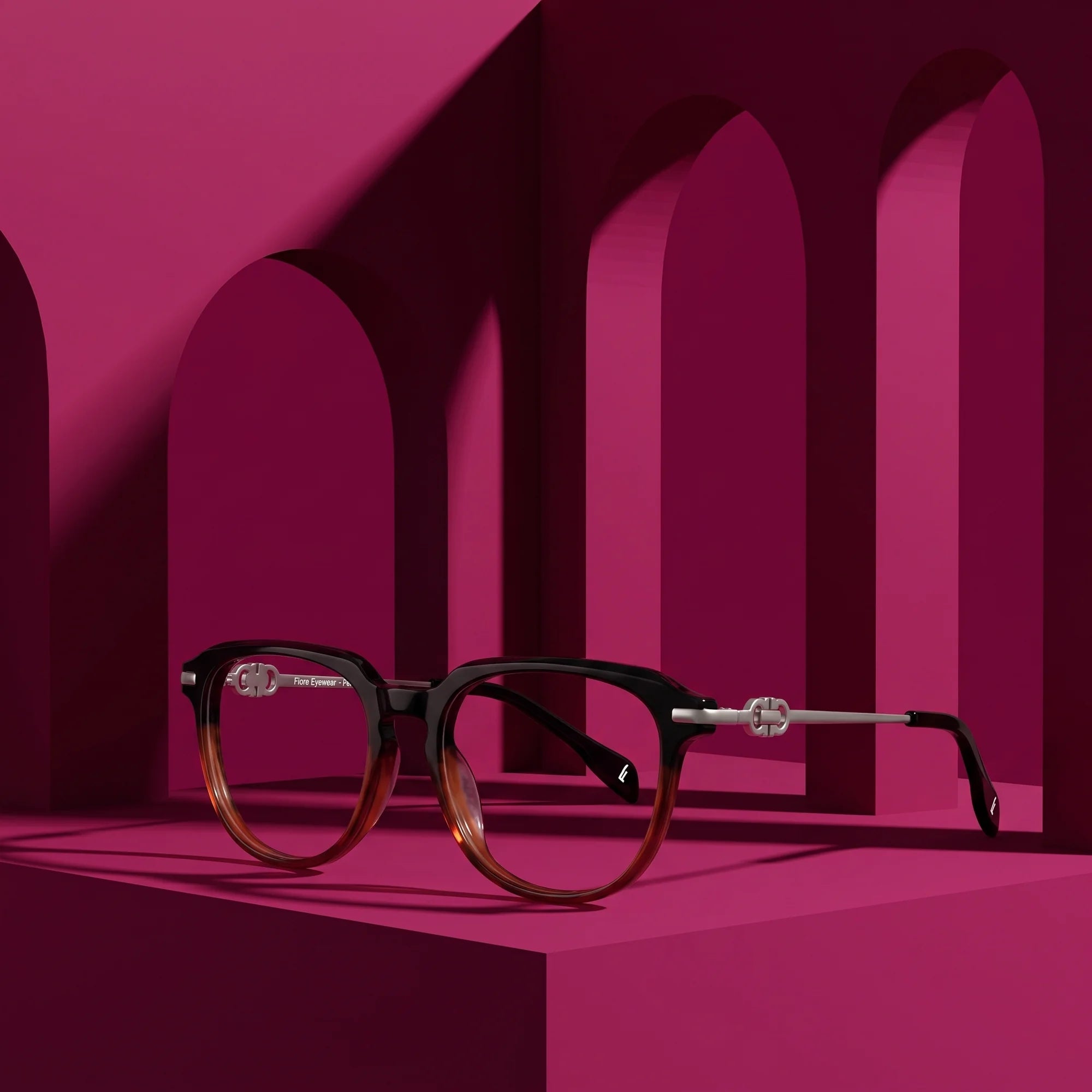 Fiore 5409 eyeglasses in black brown – displayed on a magenta podium among arches