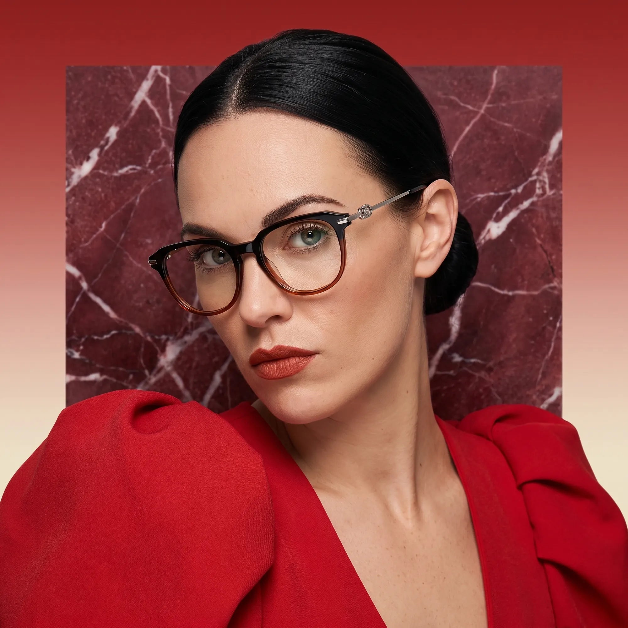 Fiore 5409 eyeglasses in black brown, worn by a model – campaign portrait, red marble backdrop and draped scarlet dress