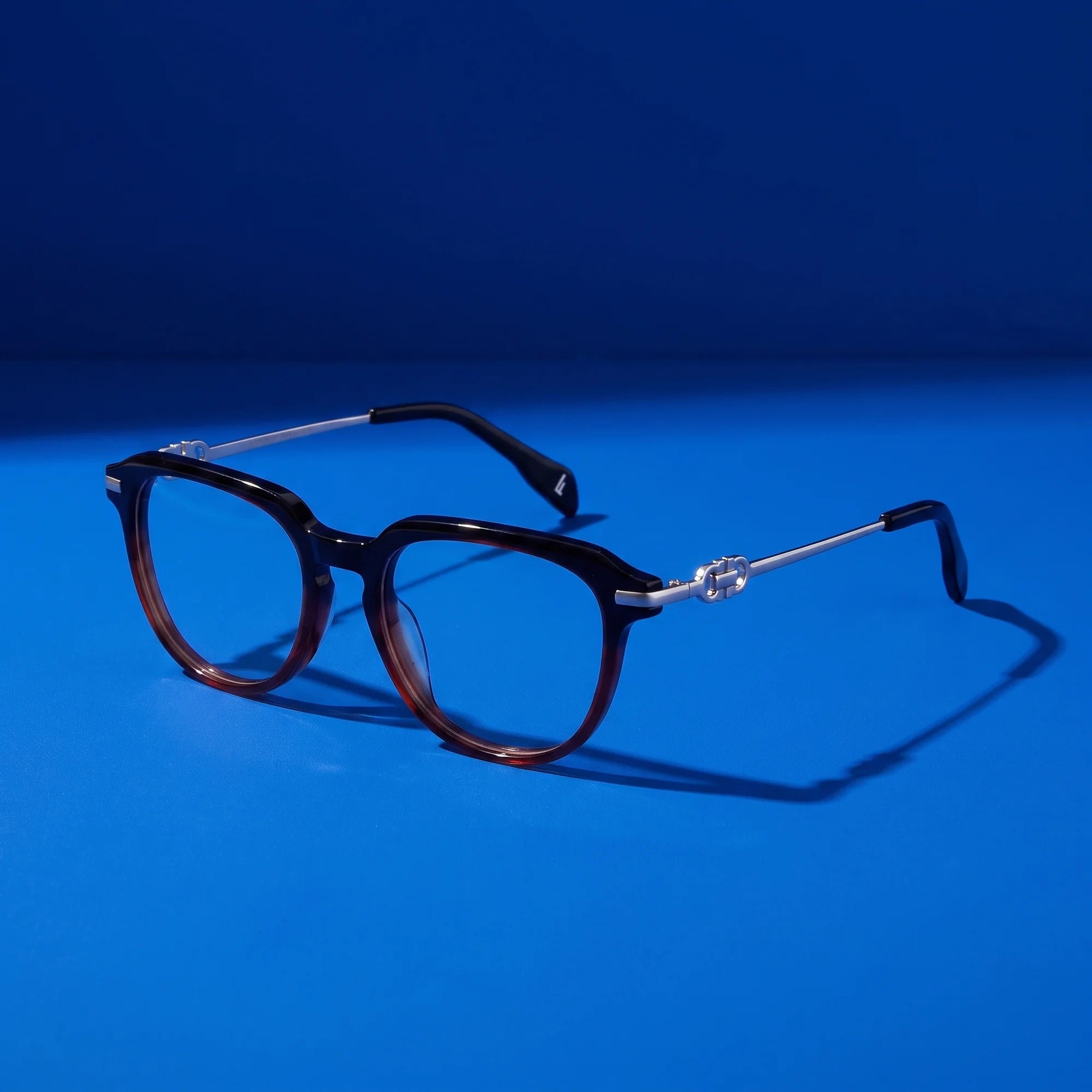 Fiore 5409 eyeglasses in black brown – still life on a seamless cobalt studio backdrop