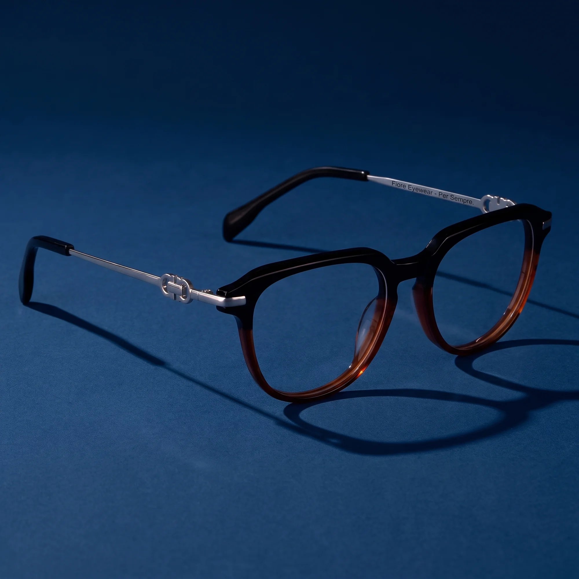 Fiore 5409 eyeglasses in black brown – hero still life against a deep midnight blue backdrop