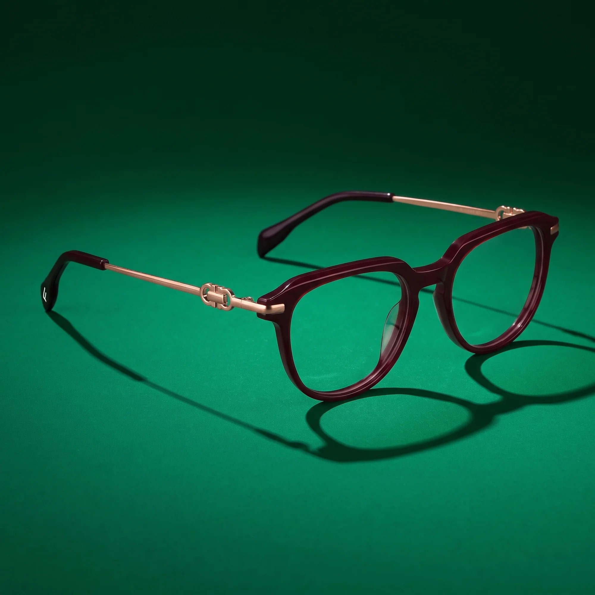 Fiore 5409 eyeglasses in brown red – editorial still life on a saturated emerald set