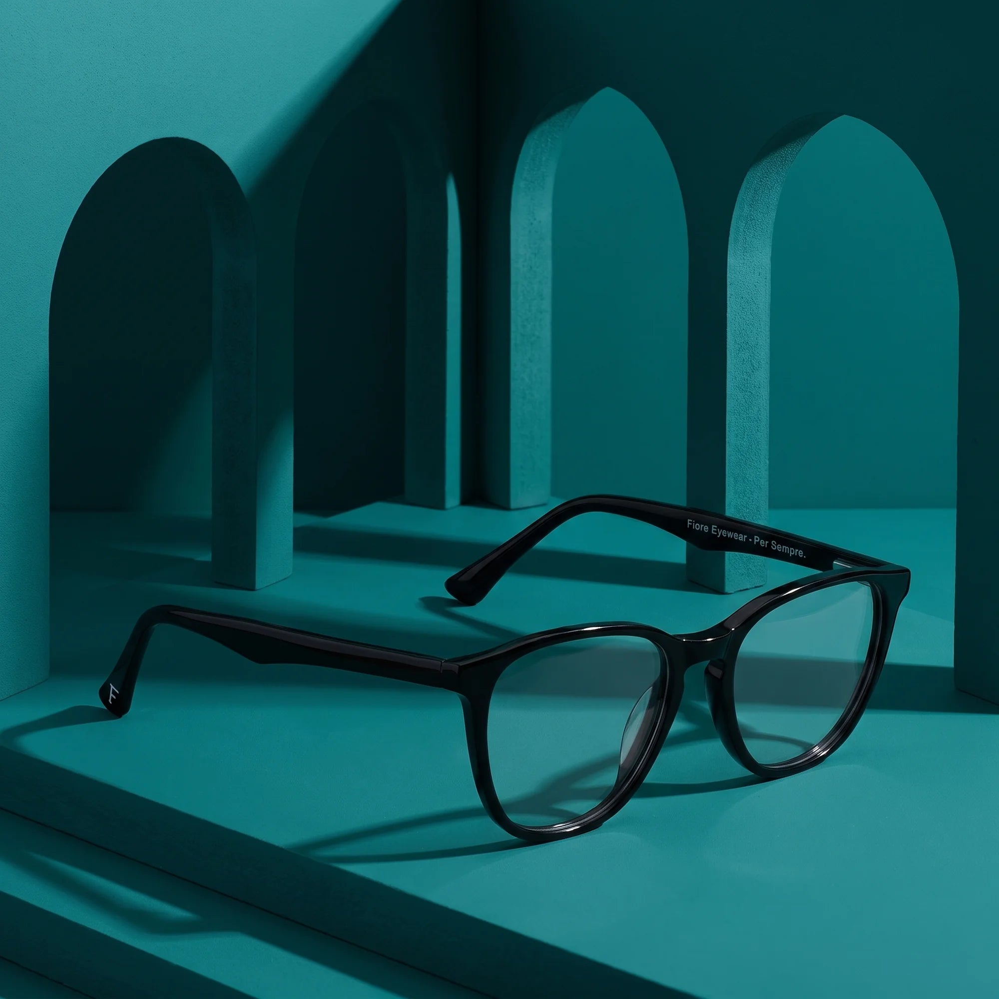 Fiore 7046 eyeglasses in black – still life among monochrome teal arches
