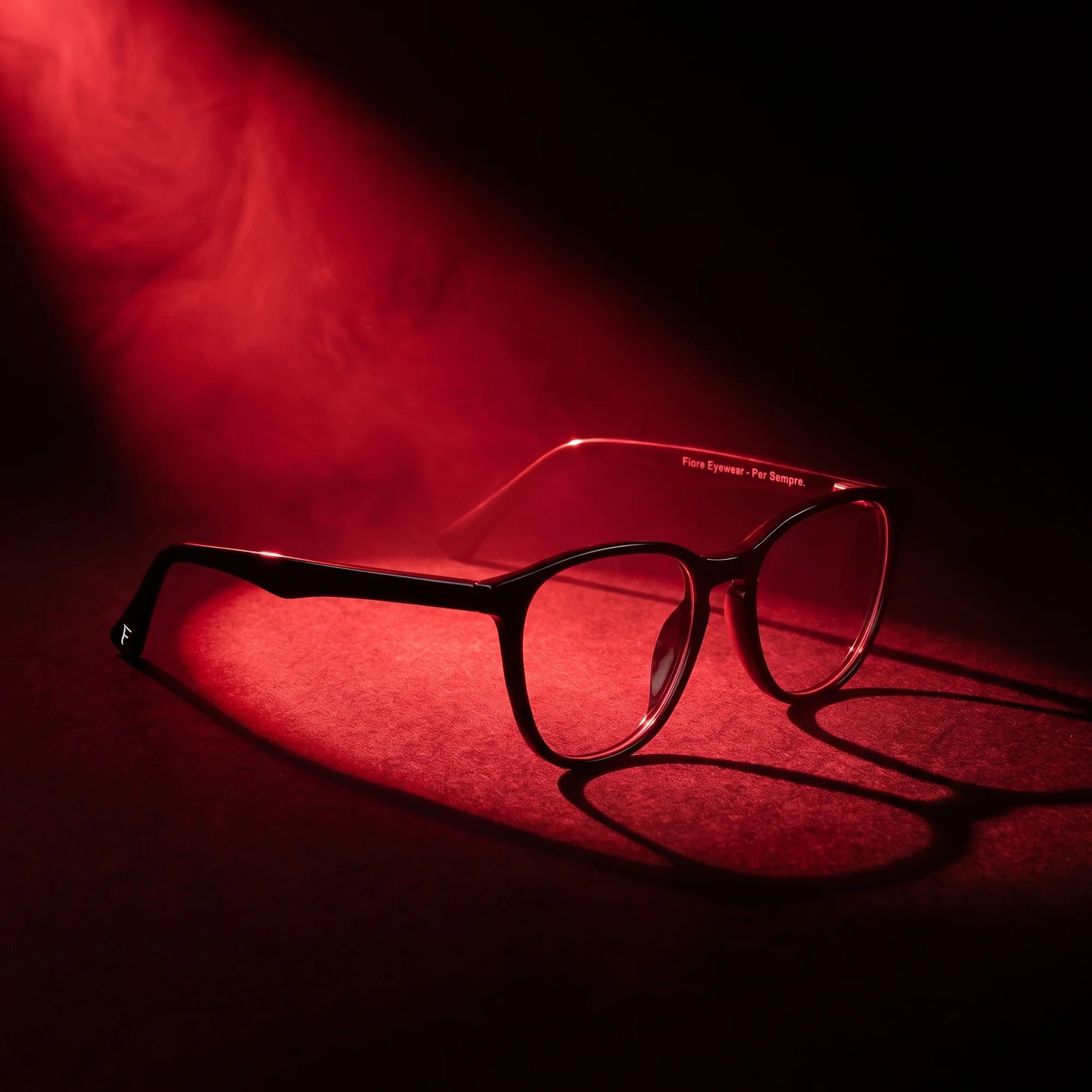 Fiore 7046 eyeglasses in black – under a theatrical beam of light