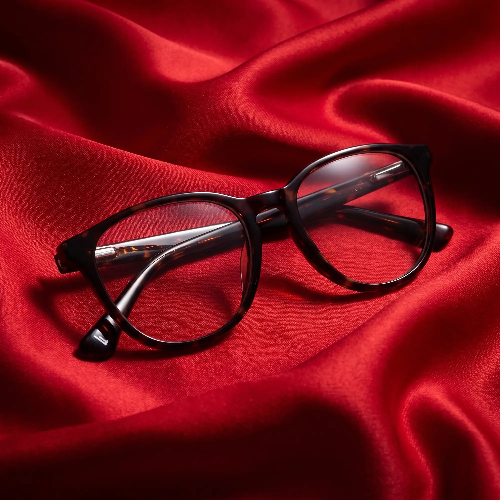 Fiore 7046 eyeglasses in tortoiseshell – nested in flowing vivid red silk