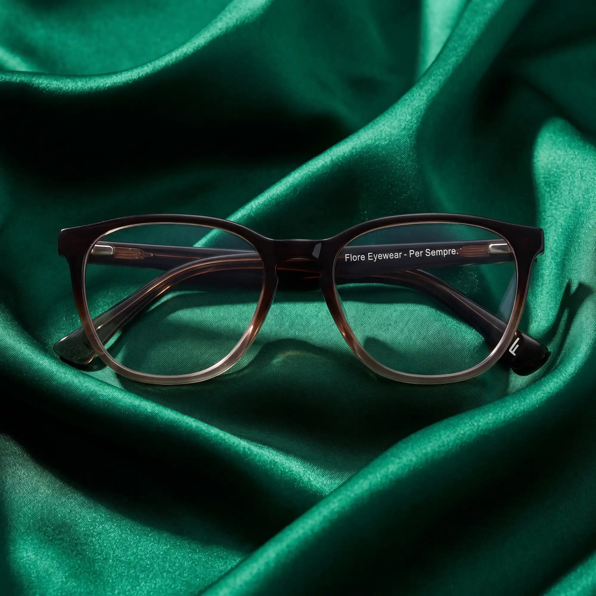 Fiore 7046 eyeglasses in gradual brown – nested in flowing emerald silk