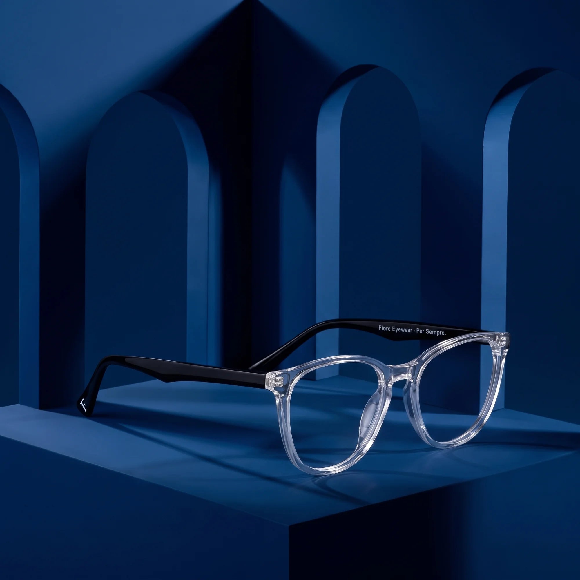 Fiore 7046 eyeglasses in transparent – still life among monochrome midnight blue arches