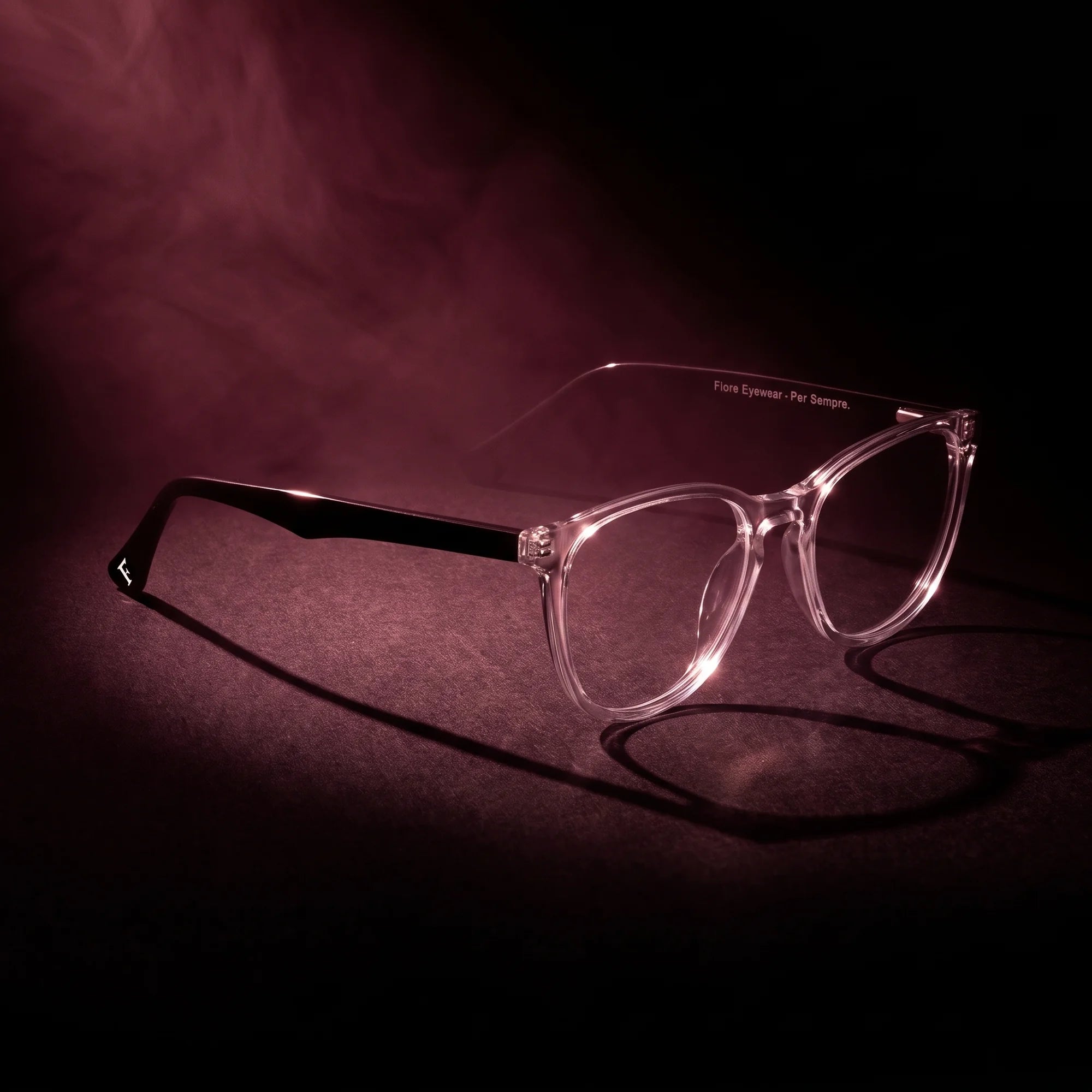 Fiore 7046 eyeglasses in transparent – under a theatrical beam of light