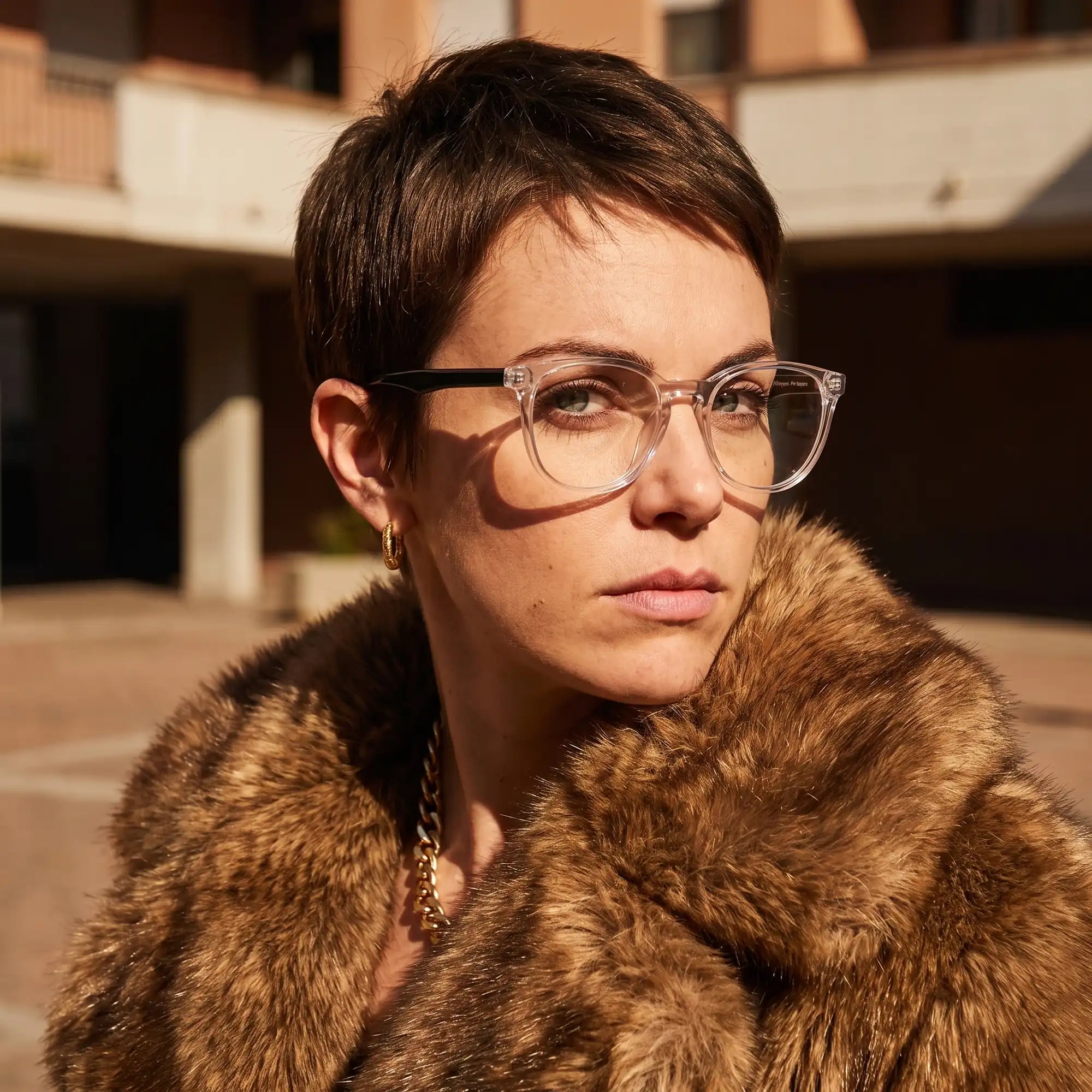 Fiore 7046 eyeglasses in transparent, worn by a model – campaign portrait, street portrait rooted in city heritage