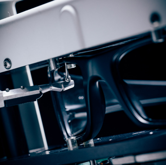 Optical lab tracing a sunglasses frame to cut custom replacement lenses